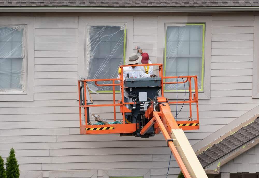 The painters of Best Team Painters is working beside the windows outside the house
